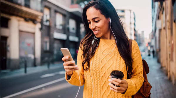 Person holding phone with one hand and scrolling with thumb.